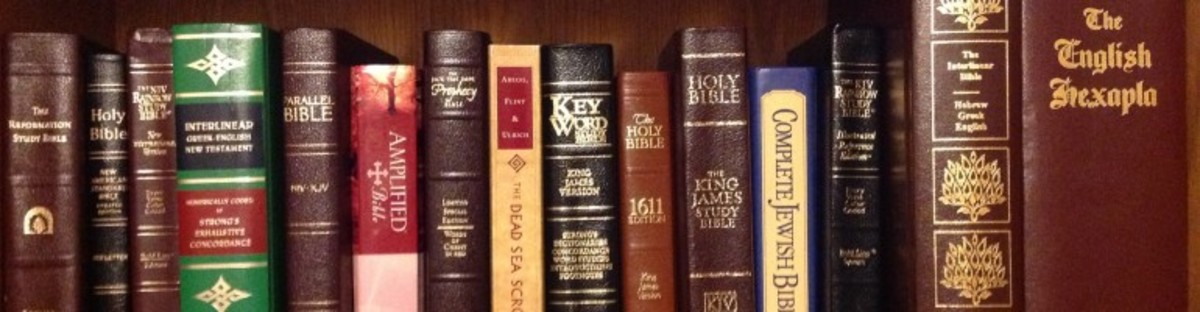 A row of spiritual books such as the Holy Bible on a bookshelf.